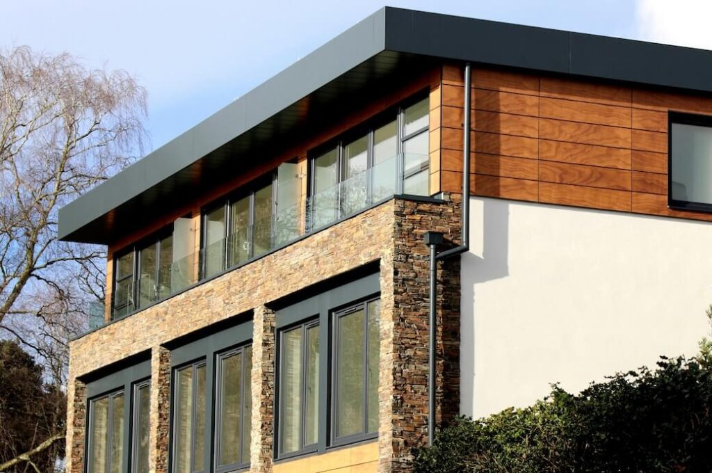 A completed new build house, timber and stone clad