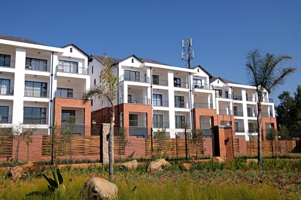 A completed new build house with a for sale board